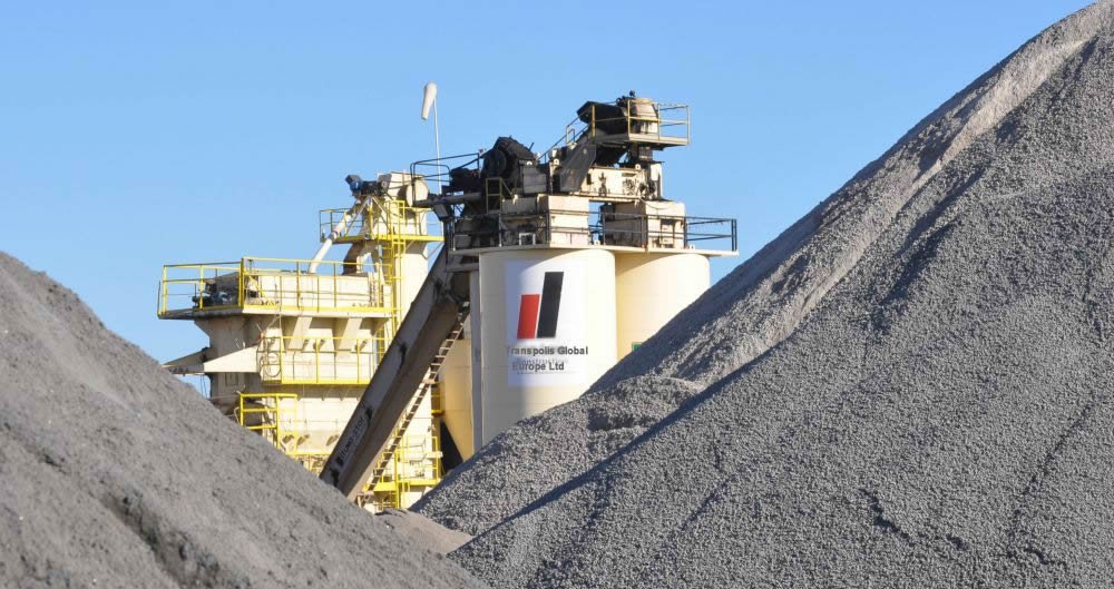 Bronte asphalt plant in distance between two granular stockpiles